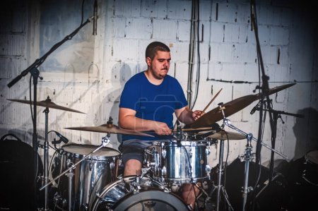 Photo for Drum music band drummer artist have solo live performance on a stage. Repetition and practice - Royalty Free Image
