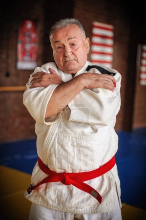 Photo for Respected and experienced judo sensei master instructor in traditional gi kimono. A skilled martial artist demonstrates his expertiset - Royalty Free Image