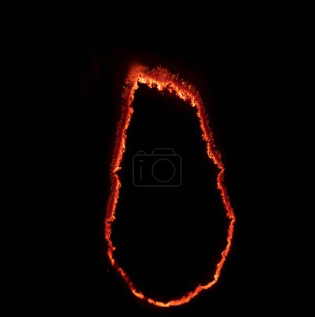 Foto de Burning paper, glowing edge of paper on a black background - Imagen libre de derechos