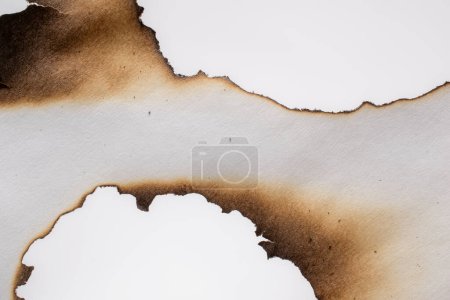 Photo for Burning paper, glowing edge of paper on a white  background - Royalty Free Image