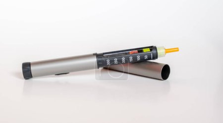 Insulin pen injector.  Insulin pen fill with needle on white background.
