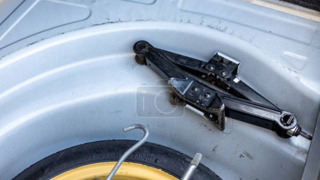 Photo for Jack in car boot for lifting car to change tyre - Royalty Free Image