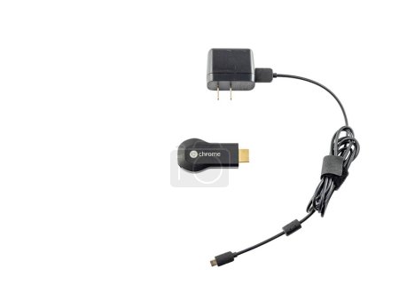 Photo for Google Chromecast HDMI-Dongle with charger on white isolated background. February 17, 2023: Swat, Pakistan. - Royalty Free Image