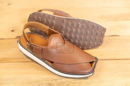 Photo for Peshawari sandal use as a formal or casual footwear in summer on wooden background closeup. - Royalty Free Image