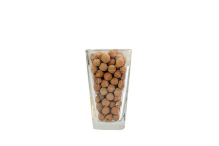 Photo for Leca clay balls artfully arranged in a transparent glass vase on white isolated background - Royalty Free Image