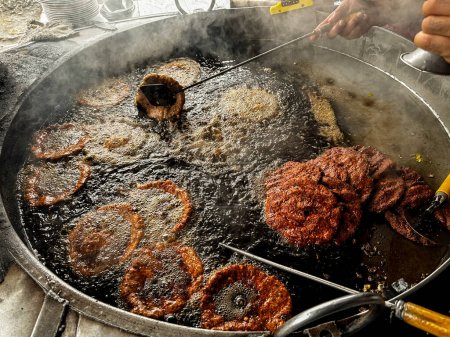 Photo for Chapli kebab is a popular street food in Pakistan. Making of chapli kabab at local food restaurant - Royalty Free Image