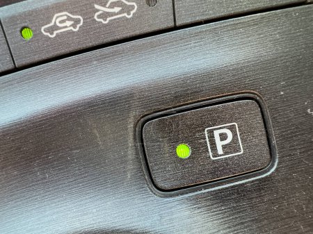 Electronic parking P symbol in automatic transmission vehicle closeup.