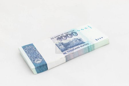 Pakistan one thousand rupees denomination note bundle on white isolated background