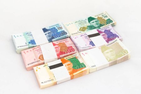 Pakistani bank notes bundles on white isolated background