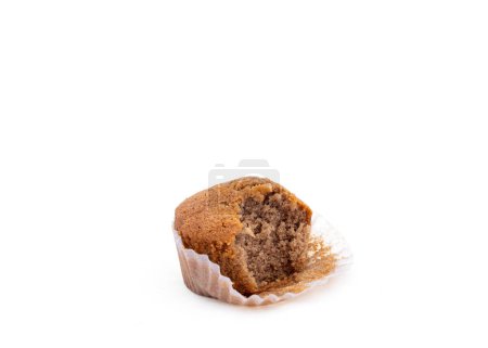 Cupcake with a bite eaten out from it on a white isolated background