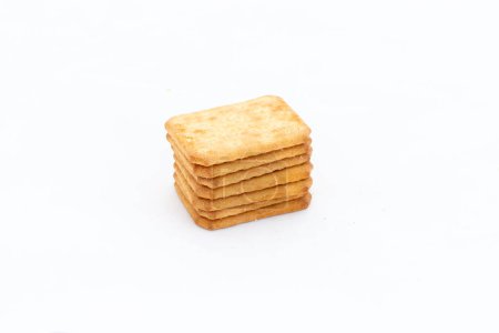 Salty crackers stacked on white background
