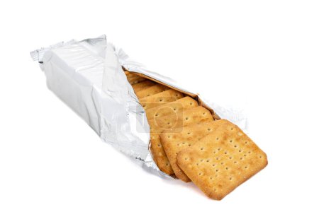 Salty crunchy cracker cookies in a wrapping paper on white isolated background