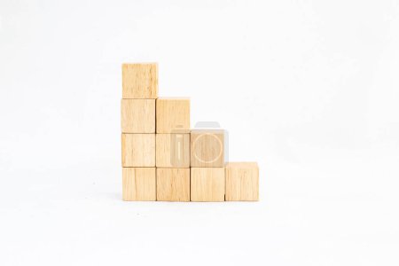Stacked wooden cubes forming an ascending staircase to the left isolated on a white background. Blank cubes space for text.