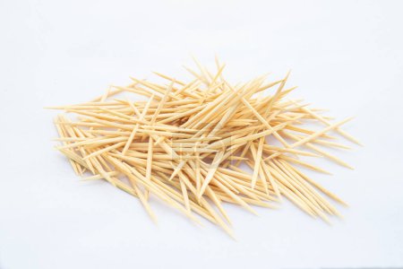 A heap of wooden toothpicks on white isolated background