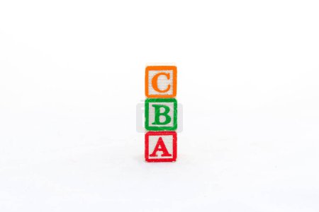 Alphabet blocks C, B and A stacked, and isolated on white background with copy space.