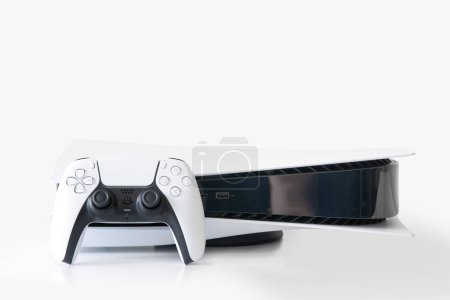 Foto de Playstation 5 and controller isolated on white background - Imagen libre de derechos
