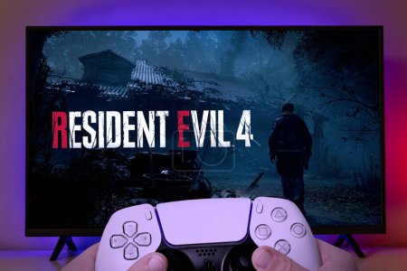 Photo for Man playing Resident Evil 4 Remake with Playstation controller on TV, 20 Mar, 2023, Sao Paulo, Brazil - Royalty Free Image