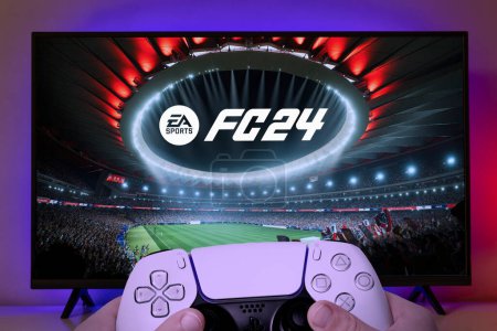 Photo for Boy playing EA FC 24 with Playstation 5 controller on TV screen, 24 Jul, 2023, Sao Paulo, Brazil - Royalty Free Image