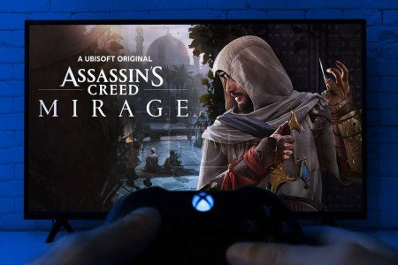 Photo for Play Assassins Creed Mirage on TV screen with Xbox controller, 2 oct, 2023, Sao Paulo, Brazil. - Royalty Free Image