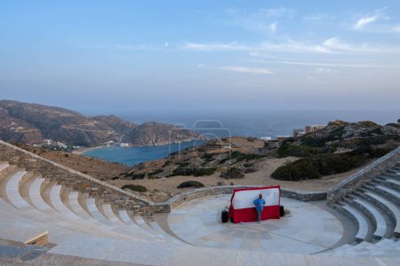 Photo for Ios, Greece - September 10, 2023 : View of a the preparation of a traditional puppet show at Odysseas Elytis outdoor theatre and the famous Mylopotas beach in the background in Ios Greece - Royalty Free Image
