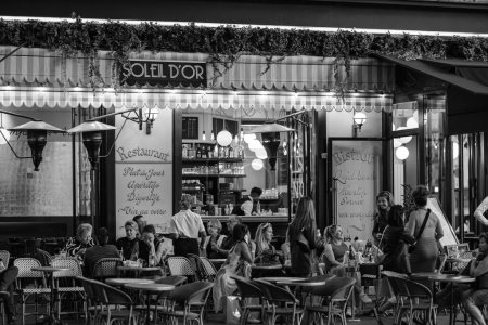 Photo for Paris, France - October 8, 2023 : View of people sitting outdoors and enjoying dinner and drinks at a restaurant bistro in Paris France - Royalty Free Image