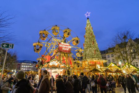 Photo for Bonn, Germany - December 16, 2023 : View of the statue of Beethoven, an illuminated Christmas tree and a Ferris Wheel at the Christmas Market in Bonn Germany - Royalty Free Image