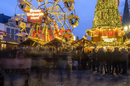 Photo for Bonn, Germany - December 16, 2023 : View of  an illuminated Christmas tree and a Ferris Wheel at the Christmas Market in Bonn Germany - Royalty Free Image