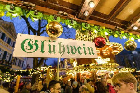 Foto de Bonn, Alemania - 16 de diciembre de 2023: Vista de un bar de Navidad iluminado que vende Glhwein, el vino caliente en el mercado de Navidad en Bonn Alemania por la noche - Imagen libre de derechos