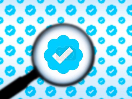 Photo for Seattle, WA USA - circa November 2022: Out of focus image of a magnifying glass zooming in on the Twitter Verification logo. - Royalty Free Image