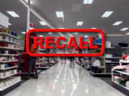 Blurry focus on a customer shopping inside a grocery store with the word Recall in the foreground