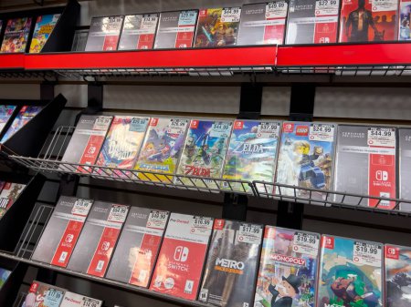 Photo for Seattle, WA USA - circa December 2022: Selective focus on used video games for sale inside a GameStop gaming store. - Royalty Free Image
