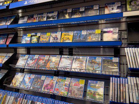 Photo for Seattle, WA USA - circa December 2022: Selective focus on used video games for sale inside a GameStop gaming store. - Royalty Free Image
