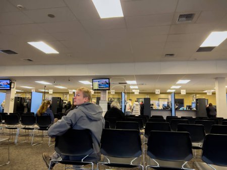 Photo for Lynnwood, WA USA - circa November 2022: Wide view of people inside the Lynnwood DMV building, updating and applying for licenses. - Royalty Free Image