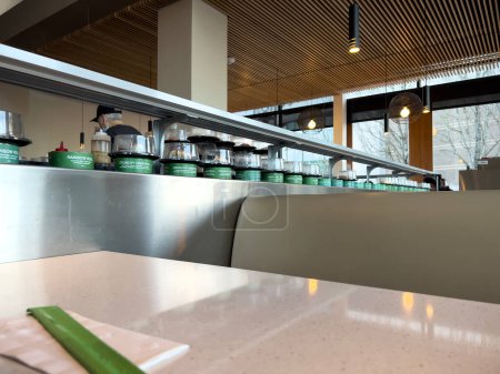 Photo for Lynnwood, WA USA - circa January 2023: Selective focus on fresh sushi on a conveyor belt inside Bitty Fish Japanese restaurant at the Alderwood Mall. - Royalty Free Image