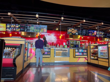 Photo for Lynnwood, WA USA - circa July 2023: Wide view of someone ordering concessions at an AMC movie theater. - Royalty Free Image