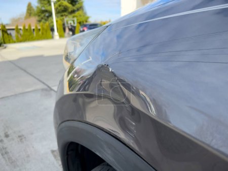 Photo for Close up view of a dent on the left side of a gray vehicle - Royalty Free Image