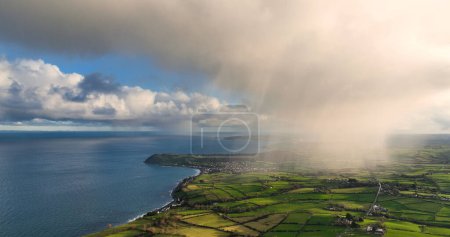 Photo for Light rain mizzle clouds over Ballygally on the Co Antrim Northern Ireland - Royalty Free Image