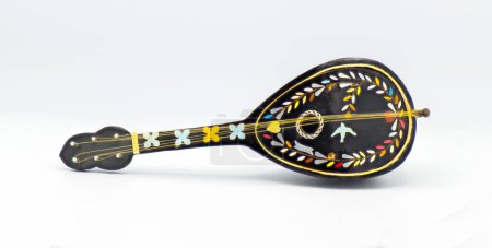 Photo for Beautiful black old antique bouzouki toy music box with multi colored ornate inlay of yellow, blue, red, pink, orange, blue and cat gut strings with a round sound hole isolated on white background - Royalty Free Image