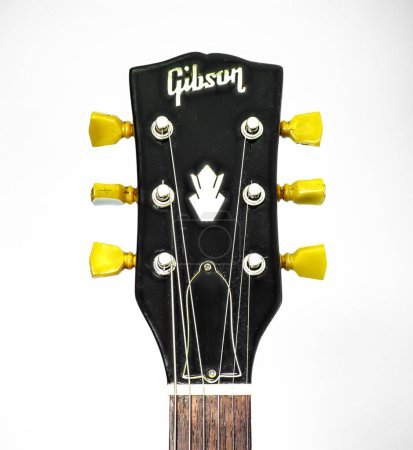 Photo for Closeup of guitar tuner or tuning pegs on black headstock.  Classic old school vintage kluson deluxe double ring circa 1966 on Gibson SG solid guitar standard, electric musical instrument - Royalty Free Image