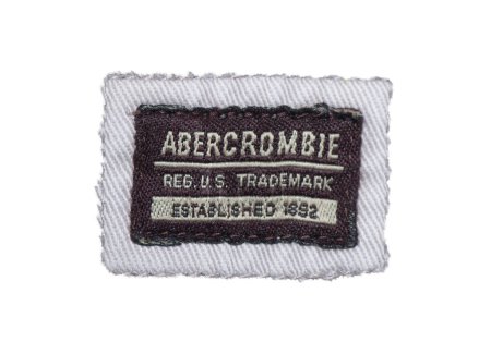 Photo for NYC February 2, 2024 Abercrombie and Fitch established 1892 trademark clothing tag label American lifestyle retailer that focuses on contemporary clothing for outdoorsmen isolated on white background - Royalty Free Image