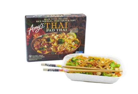 Photo for Ocala, FL 4-14-2024 Amys Pad Thai box container and cooked meal with chopsticks made with organic rice noodles, vegetables and tofu, plant based dairy and gluten free. isolated on white background - Royalty Free Image