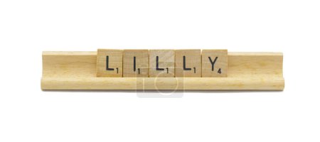 concept of popular newborn baby girl first name of LILLY made with square wooden tile English alphabet letters with natural color and grain on a wood rack holder isolated on white background