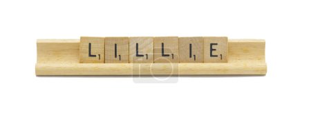 concept of popular newborn baby girl first name of LILLIE made with square wooden tile English alphabet letters with natural color and grain on a wood rack holder isolated on white background