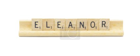 Miami, FL 4-18-24 popular newborn baby girl first name of ELEANOR made with square wooden tile English alphabet letters with natural color and grain on a wood rack holder isolated on white background