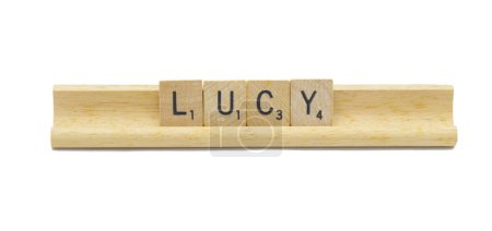 Miami, FL 4-18-24 popular baby girl first name of LUCY made with square wooden tile English alphabet letters with natural color and grain on a wood rack holder isolated on white background