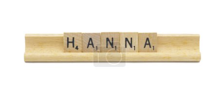 Miami, FL 4-18-24 popular baby girl first name of HANNA made with square wooden tile English alphabet letters with natural color and grain on a wood rack holder isolated on white background