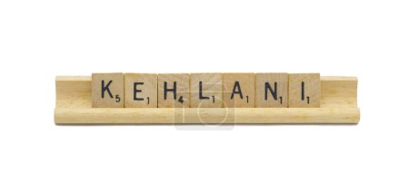 Miami, FL 4-18-24 popular baby girl first name of KEHLANI made with square wooden tile English alphabet letters with natural color and grain on a wood rack holder isolated on white background