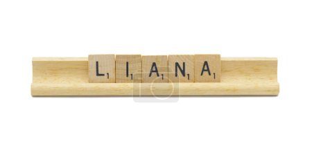 Miami, FL 4-18-24 popular baby girl first name of LIANA made with square wooden tile English alphabet letters with natural color and grain on a wood rack holder isolated on white background