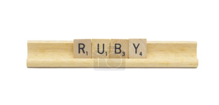 Miami, FL 4-18-24 popular baby girl first name of RUBY made with square wooden tile English alphabet letters with natural color and grain on a wood rack holder isolated on white background