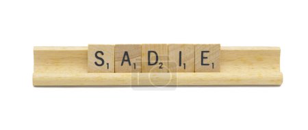Miami, FL 4-18-24 popular baby girl first name of SADIE made with square wooden tile English alphabet letters with natural color and grain on a wood rack holder isolated on white background